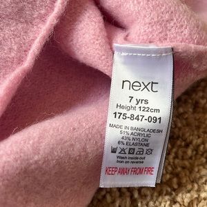 Beautiful girls light pink sweater with flair arms and adorable bow.